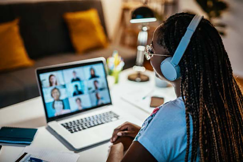 woman attending virtual meeting through her laptop