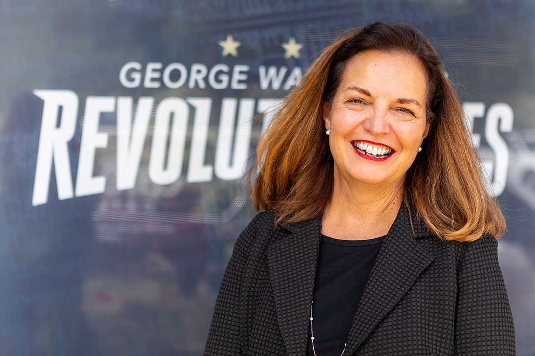 Dean Kelly-Weeder in front of GW Revolutionaries signage