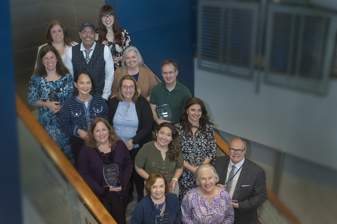 2024 Awardees posing in stairwell with awards