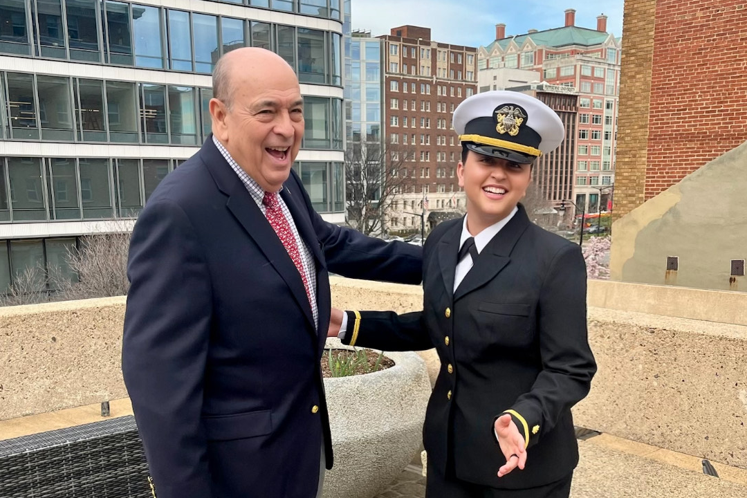 Braden Renke smiling on rooftop with her grandfather