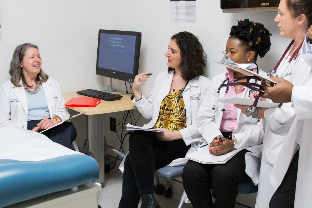 Grad students speaking to professor