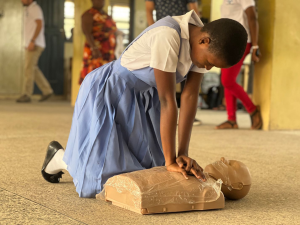 Woman practicing CPR on dummy
