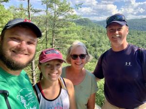 Cathi Cox with family on a hike