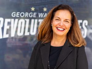 Dean Kelly-Weeder in front of GW Revolutionaries signage
