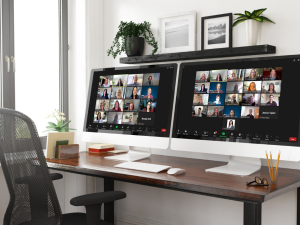 two computer monitors displaying zoom sessions with students
