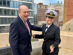 Braden Renke smiling on rooftop with her grandfather