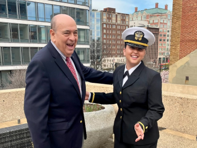 Braden Renke smiling on rooftop with her grandfather