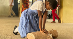 Woman practicing CPR on dummy