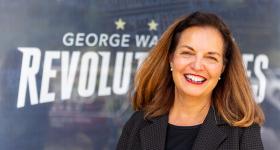 Dean Kelly-Weeder in front of GW Revolutionaries signage