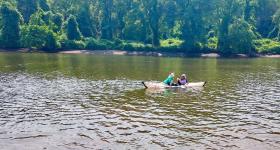 Lupu kayaking on the Anacostia with Simcha, white Swiss shepherd